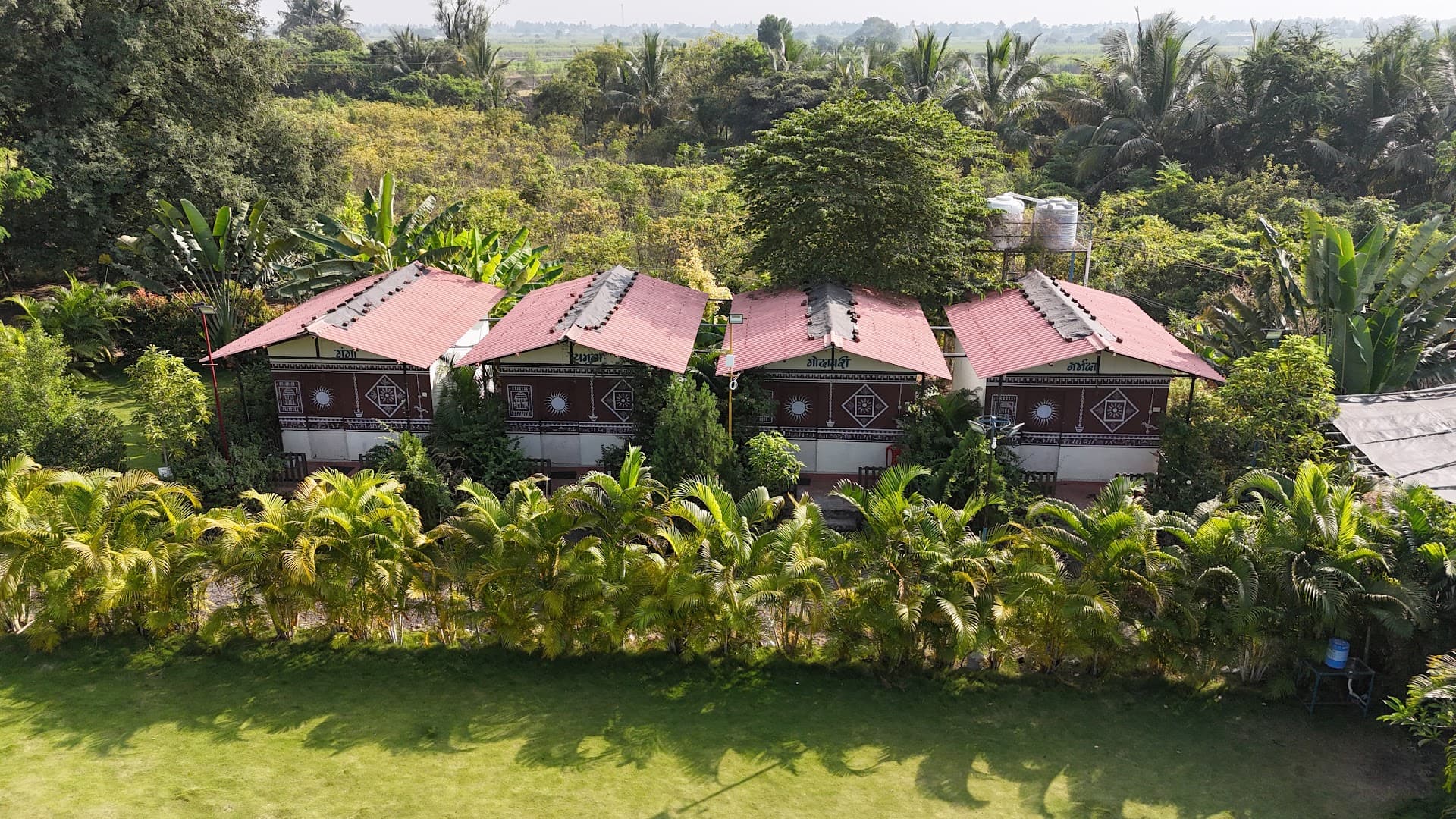 Wide aerial view of Yugankur Farmhouse property and cottages